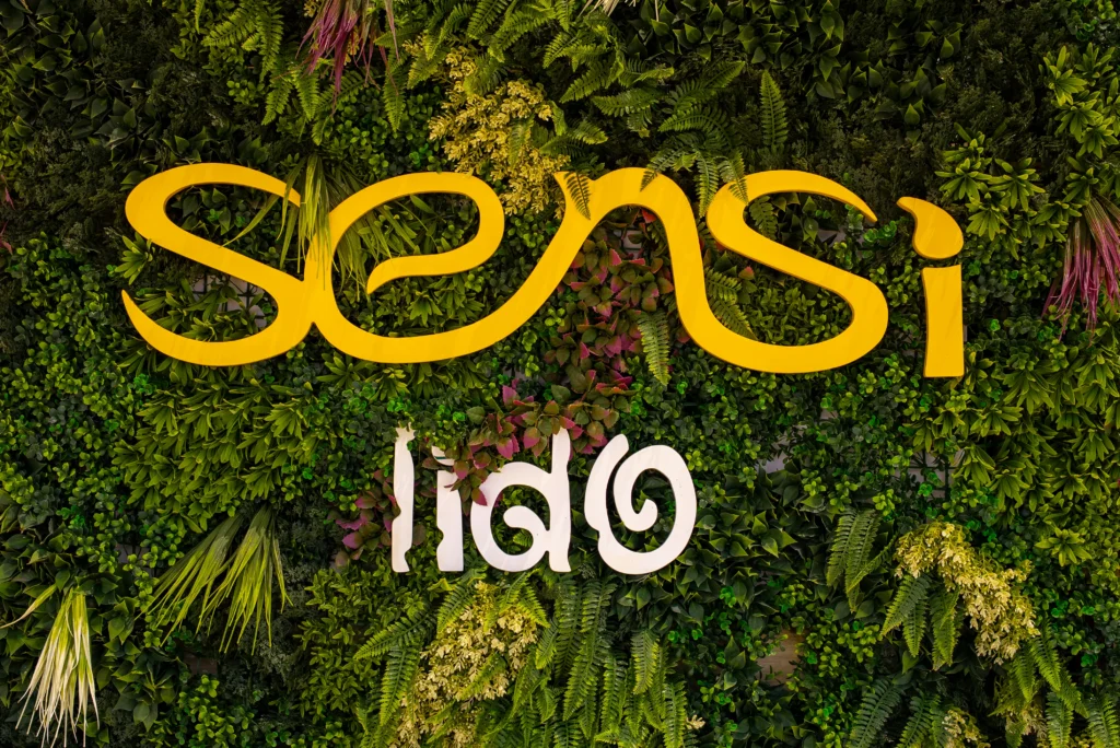 The Sensi Lido sign on a green living wall